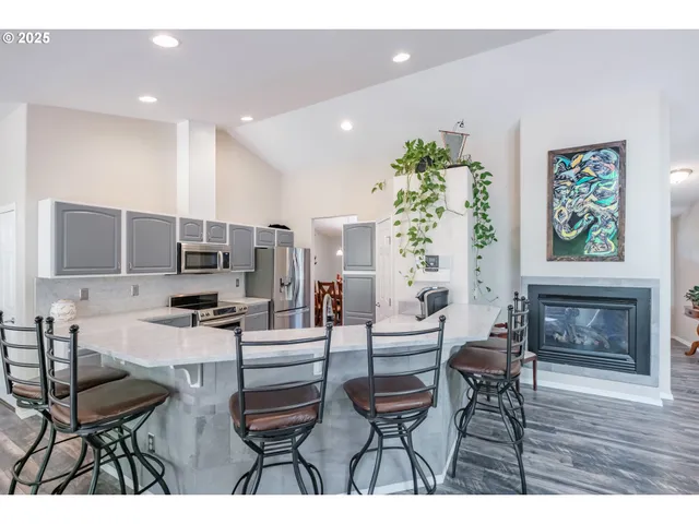 a living room with fireplace furniture and a potted plant