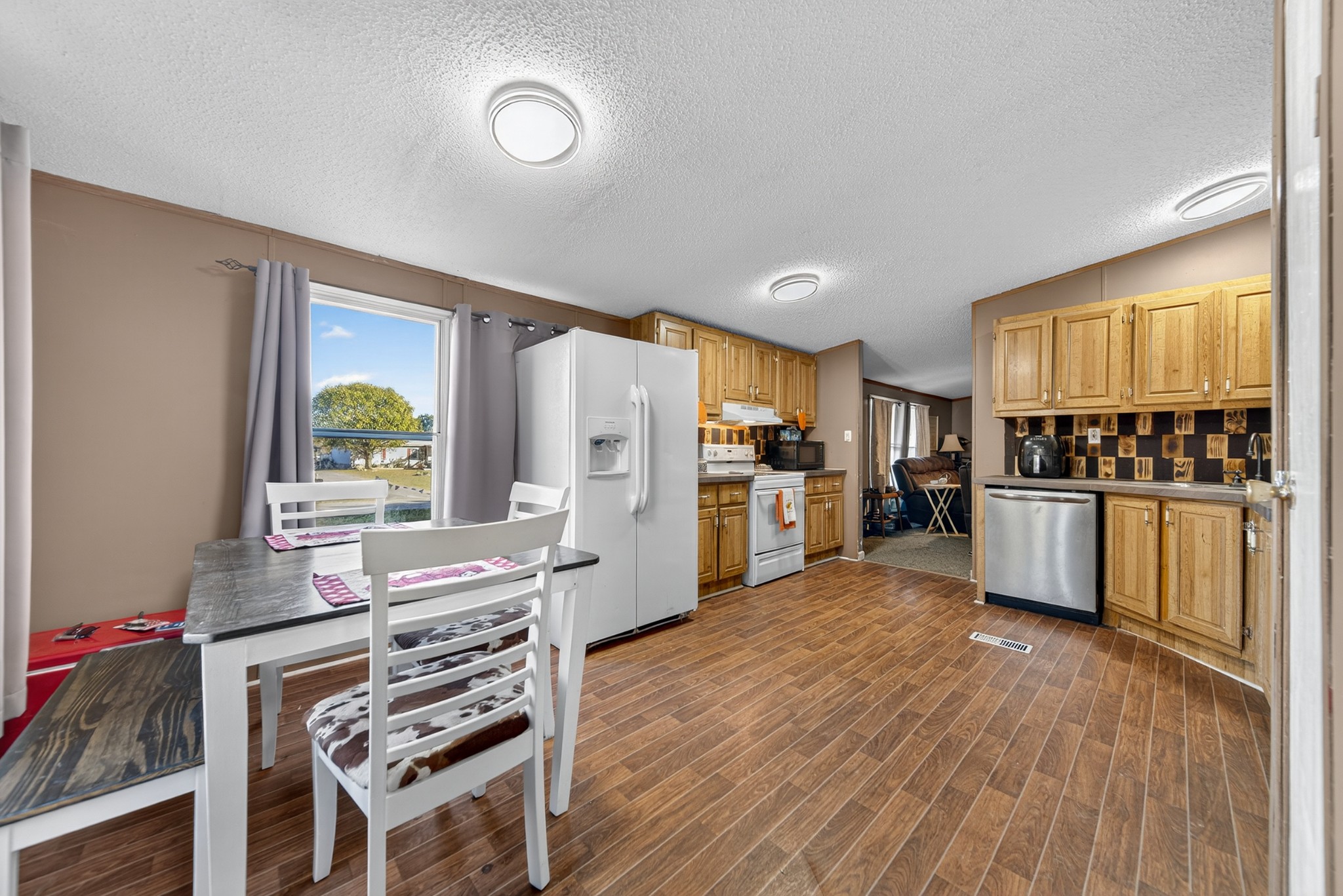 634 Pointe Lane Lafayette, TN 37083 - Photo 46 of 51 a kitchen with stainless steel appliances a stove a sink a refrigerator white cabinets and wooden floor