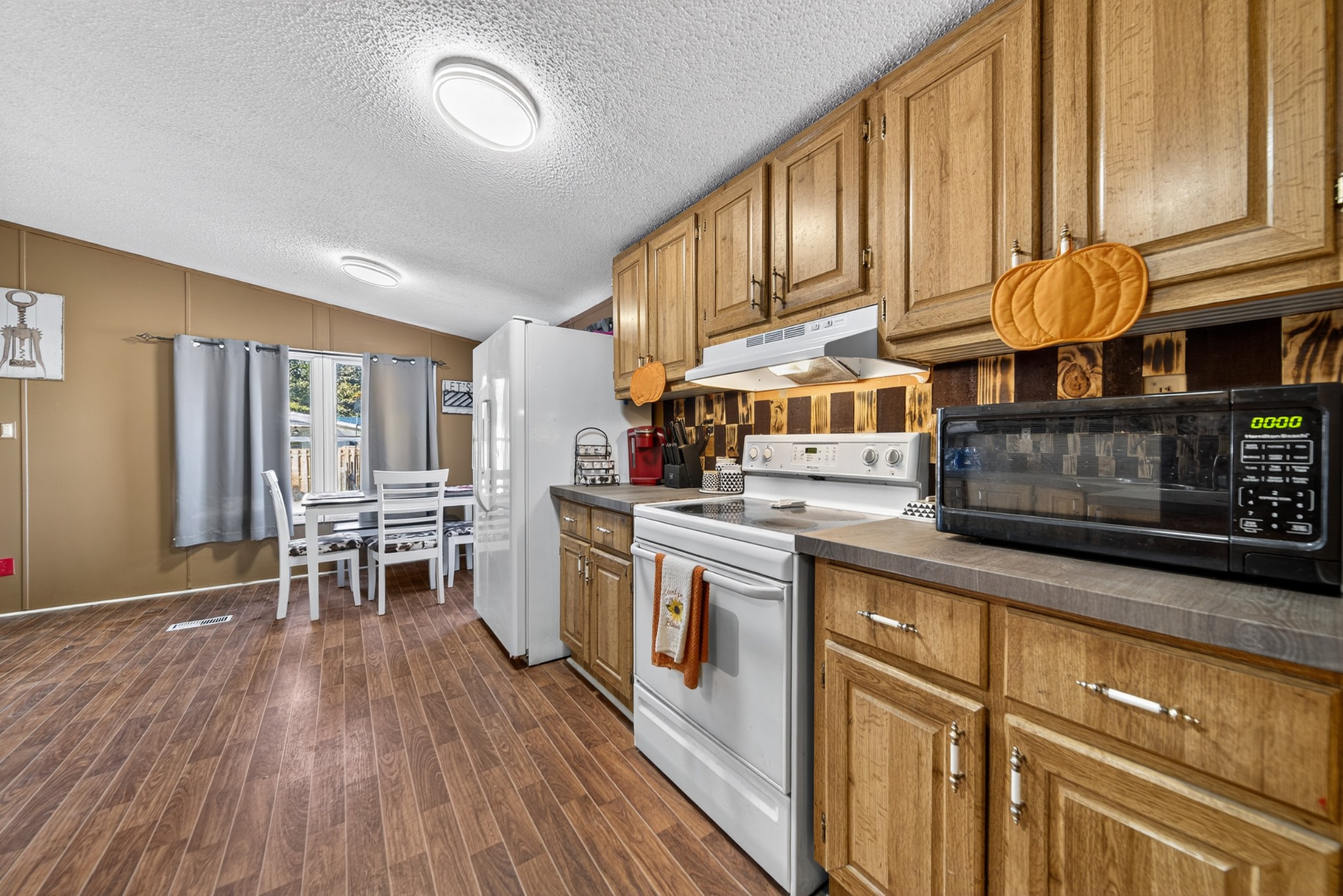 634 Pointe Lane Lafayette, TN 37083 - Photo 50 of 51 a kitchen with stainless steel appliances granite countertop a stove a sink dishwasher and a refrigerator with wooden floor