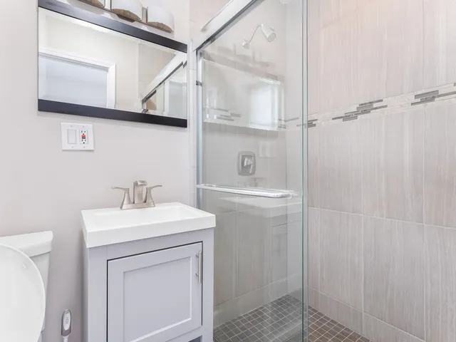 a bathroom with a sink a toilet and vanity