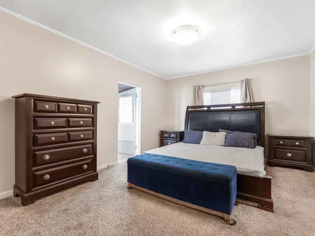 a bedroom with a bed and a dresser