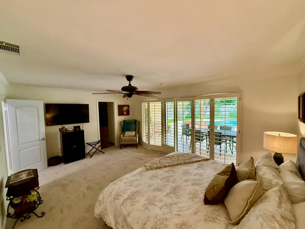 a bedroom with a bed and a television