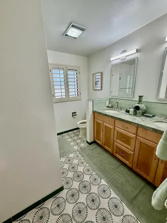 a spacious bathroom with a granite countertop sink and a bathtub