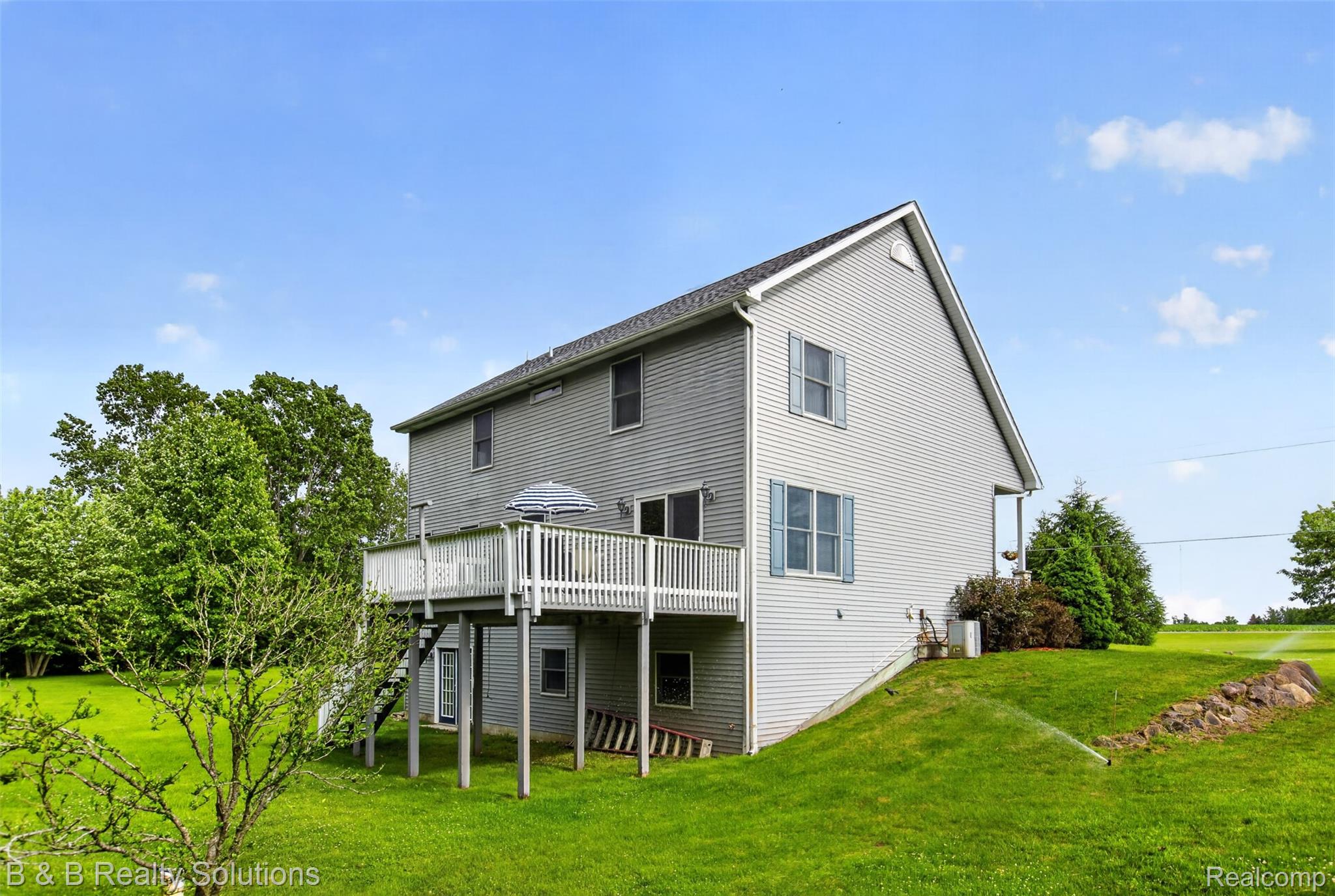 3097 East Burnside Road North Branch, MI 48461 - Photo 48 of 52 Two-story residence featuring light gray siding, white trim, and a dark shingle roof