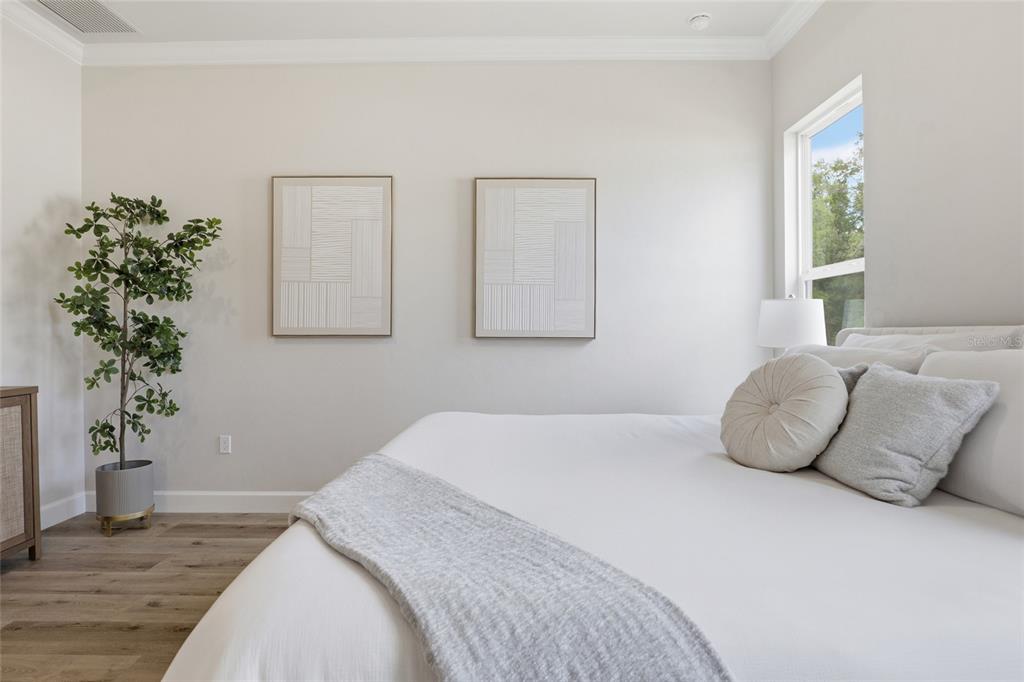 13425 Southwest 9th Road Newberry, FL 32669 - Photo 21 of 46 a bedroom with a bed and a potted plant