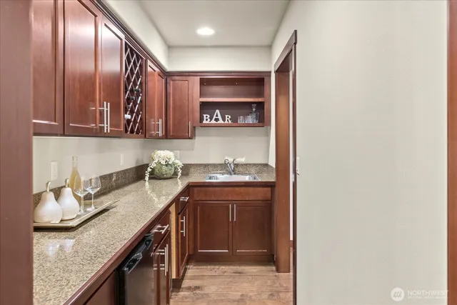 a kitchen with granite countertop stainless steel appliances and sink