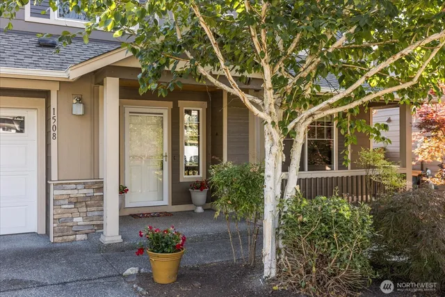a front view of a house with potted plants