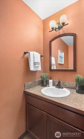 a bathroom with a sink vanity and a mirror