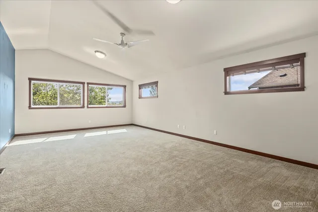 an empty room with windows and closet