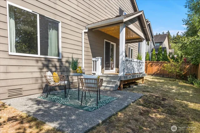 a view of house with a backyard and sitting area