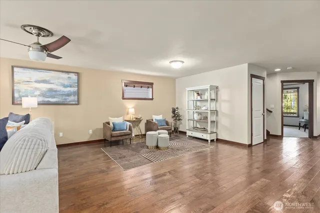 a living room with furniture and wooden floor