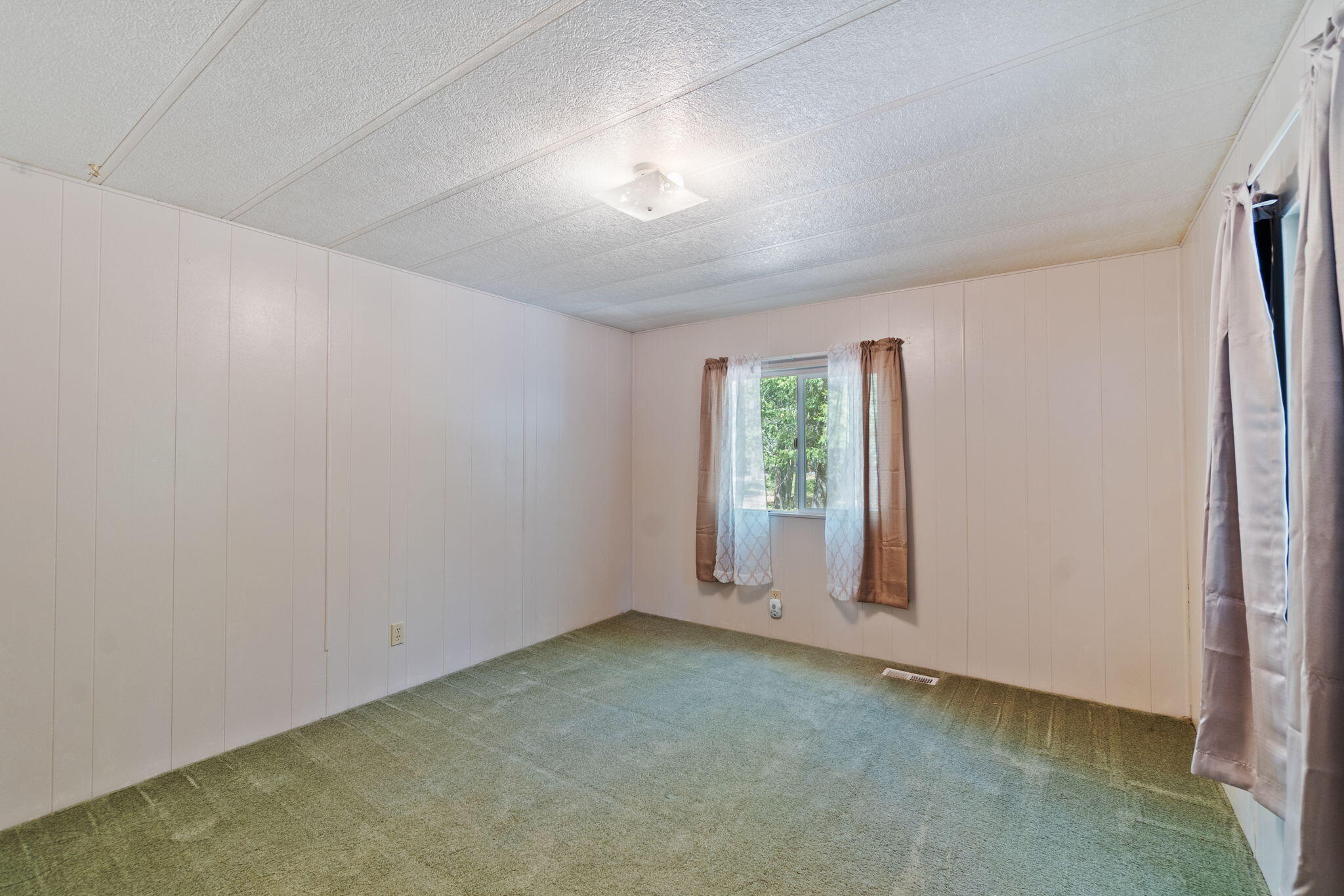 7517 Brett Road Shingletown, CA 96088 - Photo 6 of 26 an empty room with windows