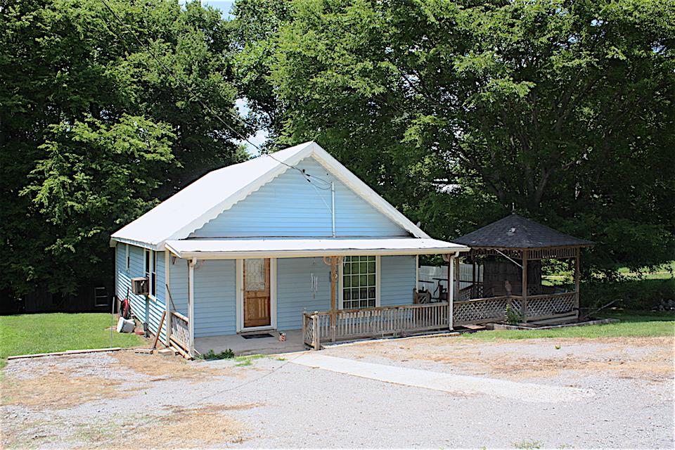 2734 Battle Creek Road Springfield, TN 37172 - Photo 2 of 8 a front view of a house with a garden and trees