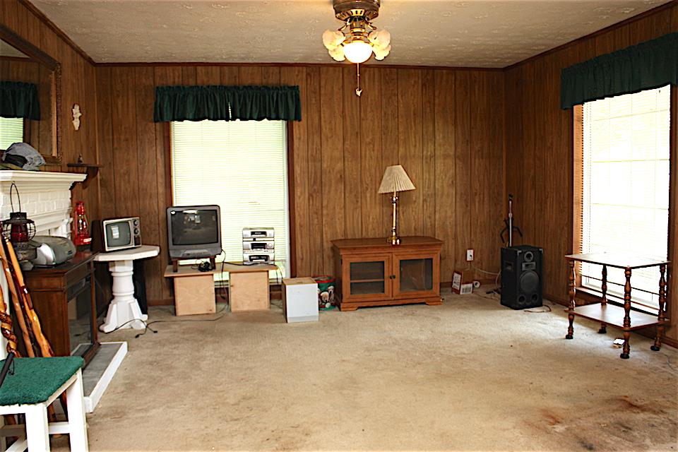2734 Battle Creek Road Springfield, TN 37172 - Photo 4 of 8 a view of a livingroom with furniture a flat screen tv and kitchen view