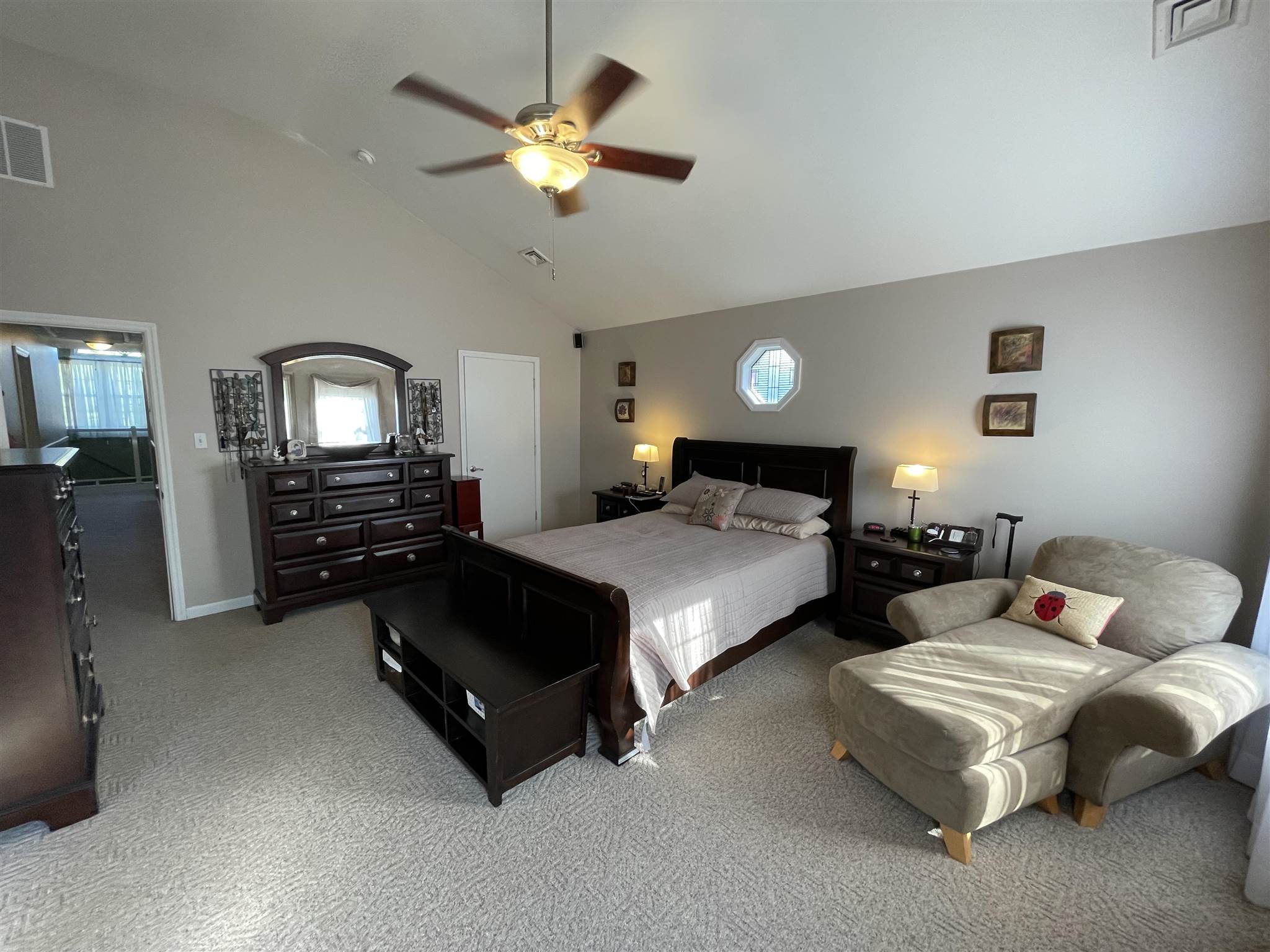 333 Shore Road Somers Point, NJ 08244 - Photo 18 of 25 a spacious bedroom with a bed a chandelier and a dresser