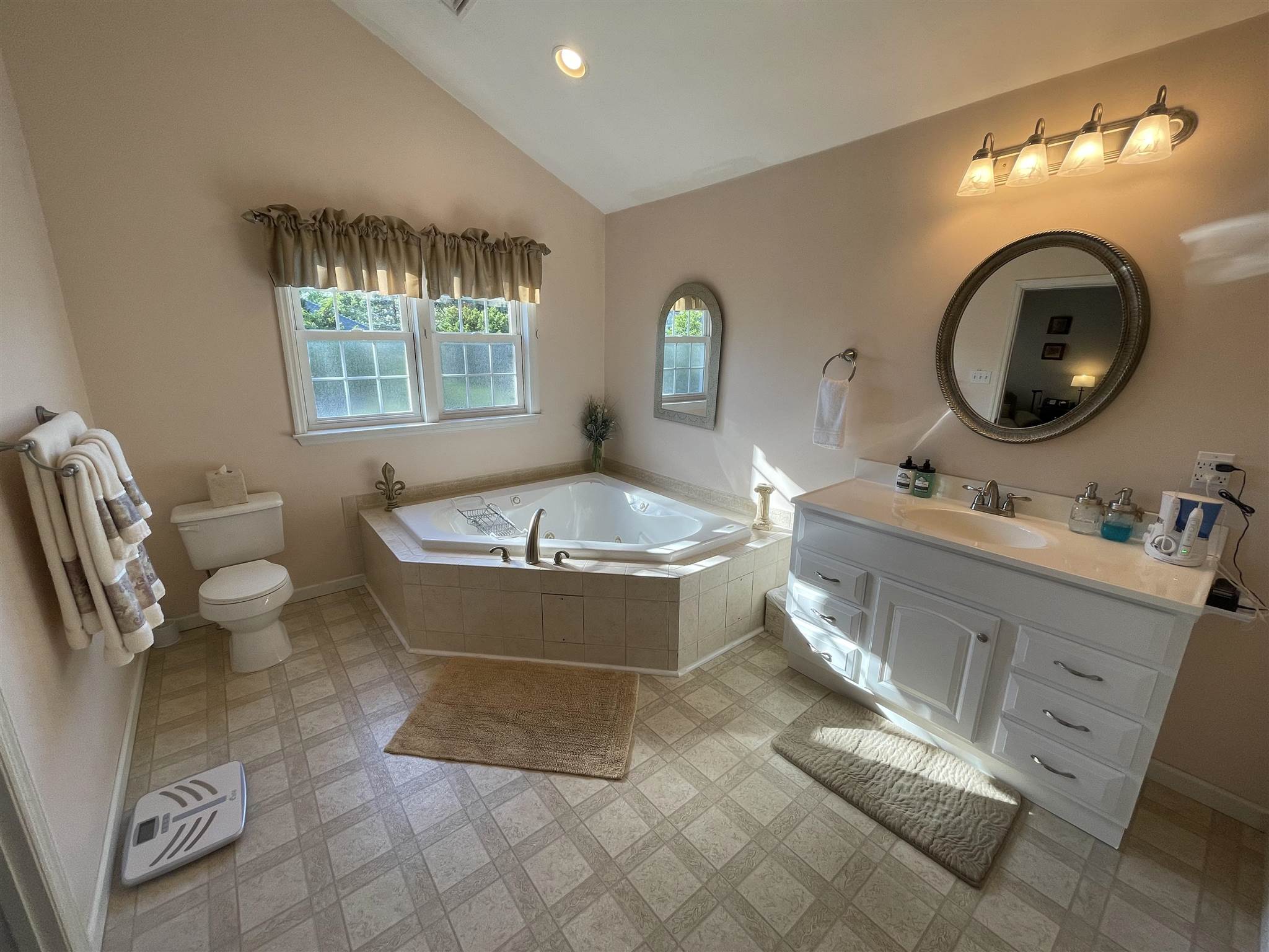 333 Shore Road Somers Point, NJ 08244 - Photo 19 of 25 a spacious bathroom with a bathtub a sink and a mirror