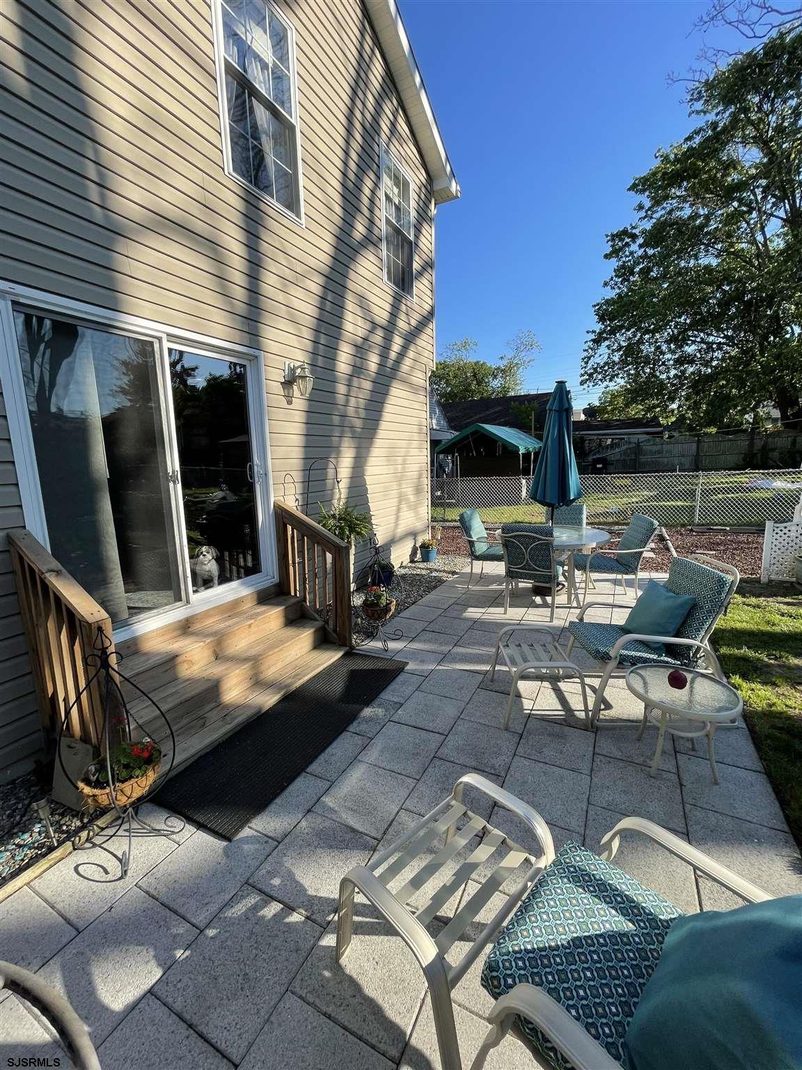 333 Shore Road Somers Point, NJ 08244 - Photo 24 of 25 a view of a patio with couches table and chairs under an umbrella