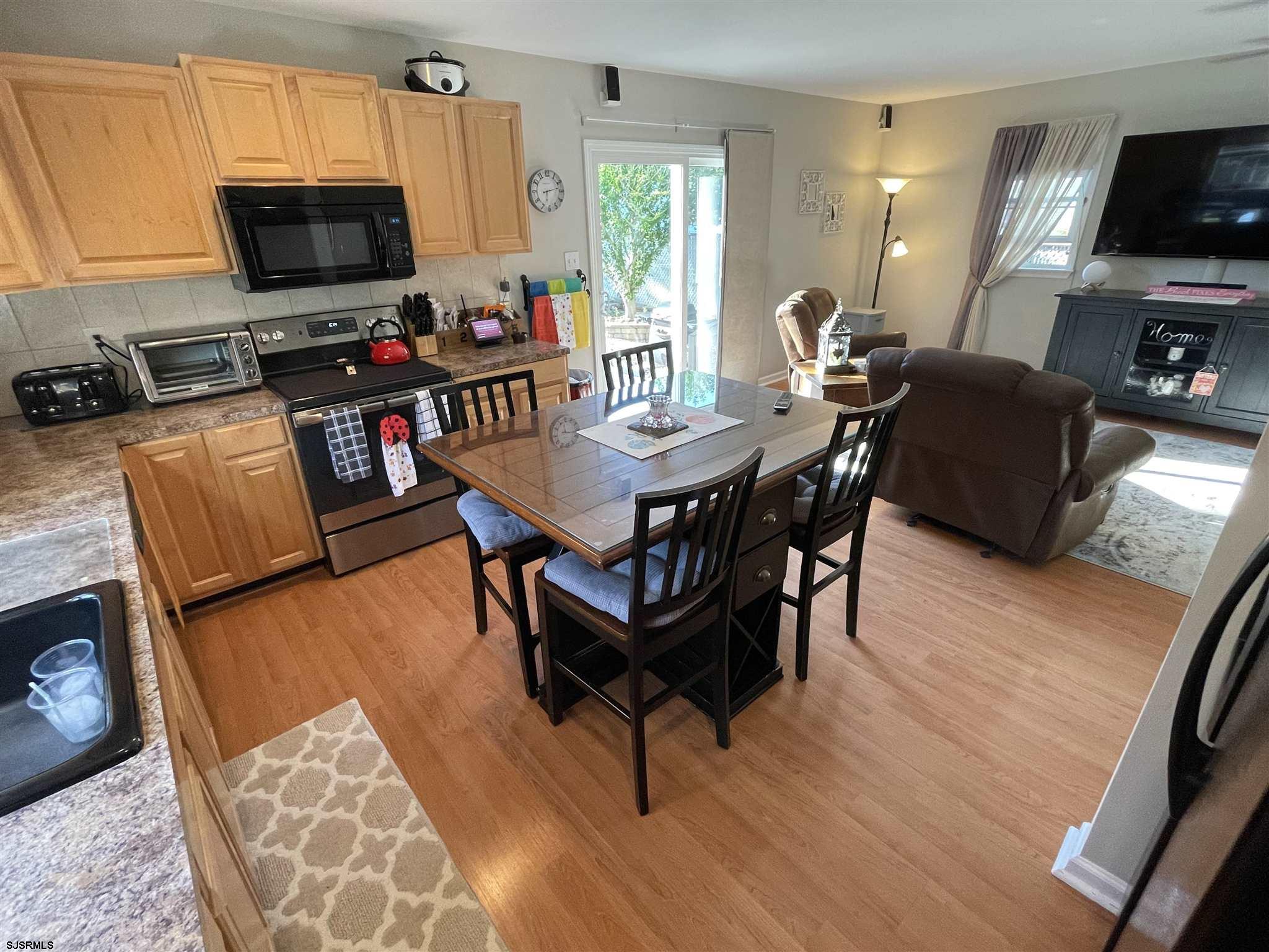 333 Shore Road Somers Point, NJ 08244 - Photo 7 of 25 a living room with furniture a flat screen tv and kitchen view
