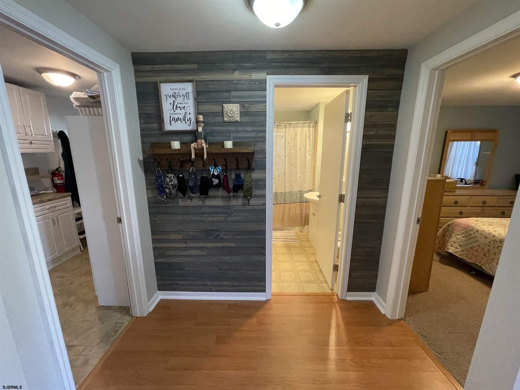 333 Shore Road Somers Point, NJ 08244 - Photo 8 of 25 a view of a hallway with a livingroom and a hall with wooden floor