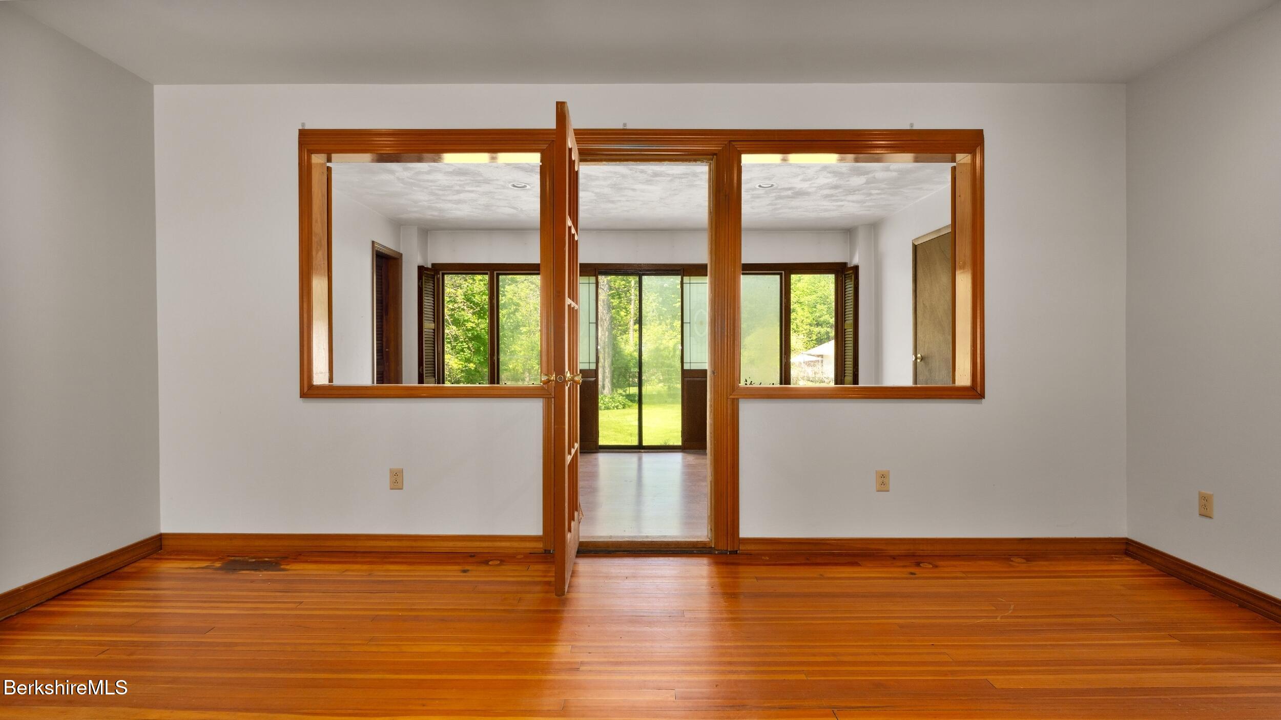 20 East Dugway Road Lenox, MA 01240 - Photo 20 of 84 a view of an empty room with wooden floor and a window