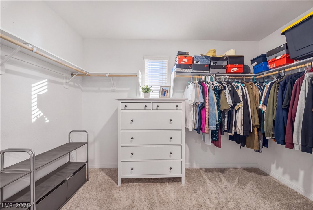 12240 Golden Wreath Road, Unit 2 Las Vegas, NV 89183 - Photo 18 of 29 A spacious walk-in closet includes carpet flooring and extensive built-in hanging rods.