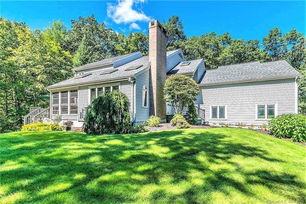 a front view of house with yard and green space
