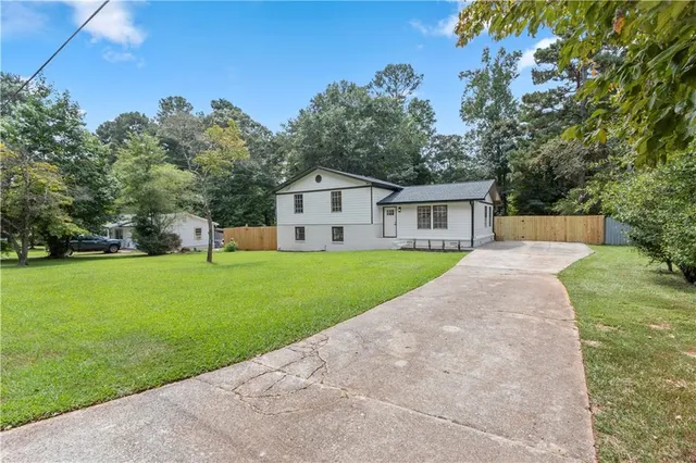a view of a house with a yard and a garden