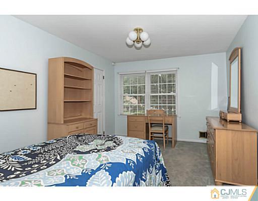 14 Fox Hill Road Edison, NJ 08820 - Photo 12 of 22 a bedroom with a bed dresser and a window