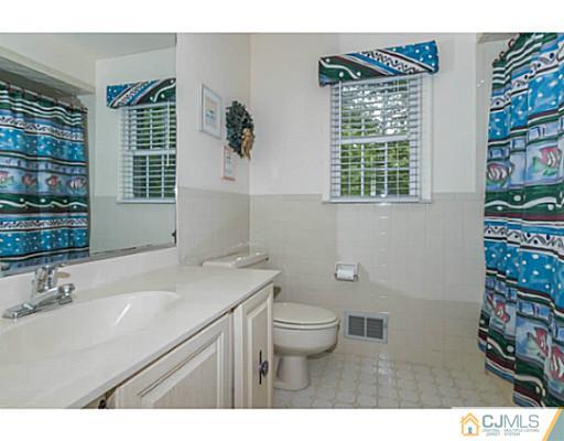 14 Fox Hill Road Edison, NJ 08820 - Photo 14 of 22 a bathroom with a sink a toilet and a window