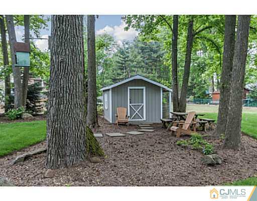 14 Fox Hill Road Edison, NJ 08820 - Photo 17 of 22 a backyard of a house with large trees and wooden fence