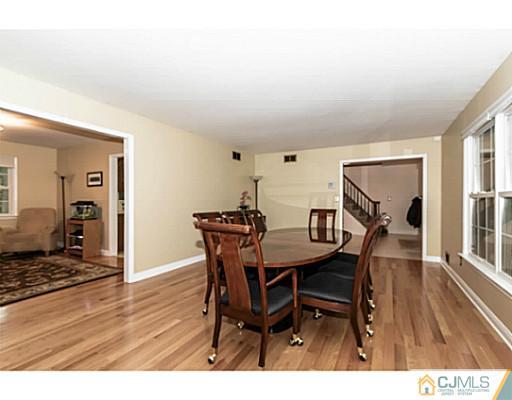 14 Fox Hill Road Edison, NJ 08820 - Photo 4 of 22 a view of a dining room with furniture and wooden floor
