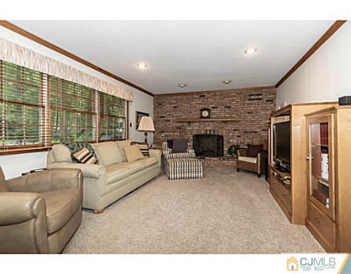 14 Fox Hill Road Edison, NJ 08820 - Photo 7 of 22 a living room with furniture a large window and a fireplace