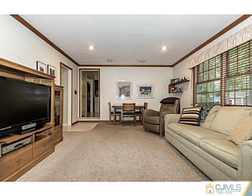 14 Fox Hill Road Edison, NJ 08820 - Photo 8 of 22 a living room with furniture and a flat screen tv