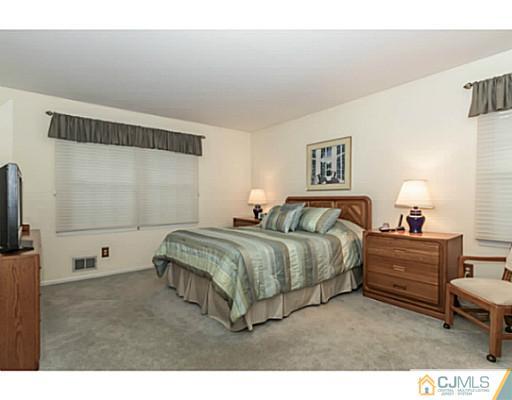 14 Fox Hill Road Edison, NJ 08820 - Photo 9 of 22 a spacious bedroom with a bed and a flat screen tv