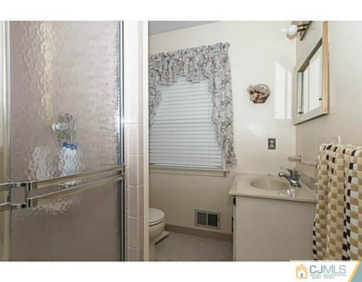 14 Fox Hill Road Edison, NJ 08820 - Photo 10 of 22 a bathroom with a sink and mirror