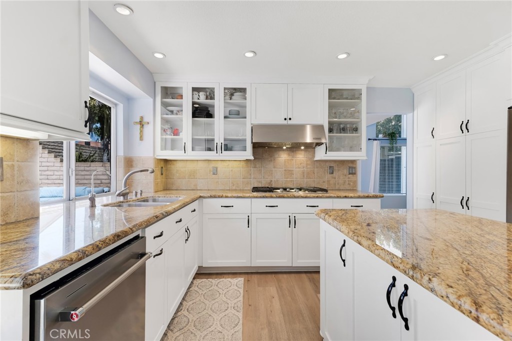 3843 San Gabriel Street Simi Valley, CA 93063 - Photo 20 of 52 a large kitchen with granite countertop a sink and white cabinets
