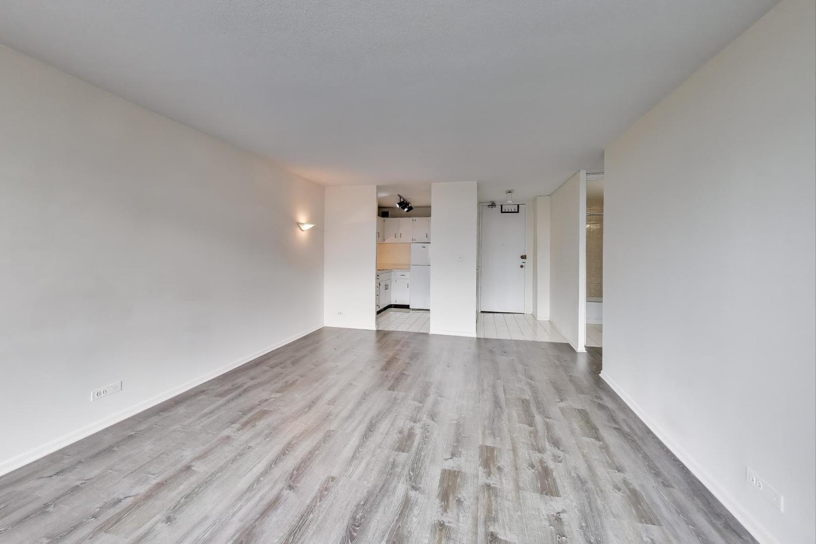 2728 North Hampden Court, Unit 1310 Chicago, IL 60614 - Photo 5 of 15 wooden floor in an empty room with a window