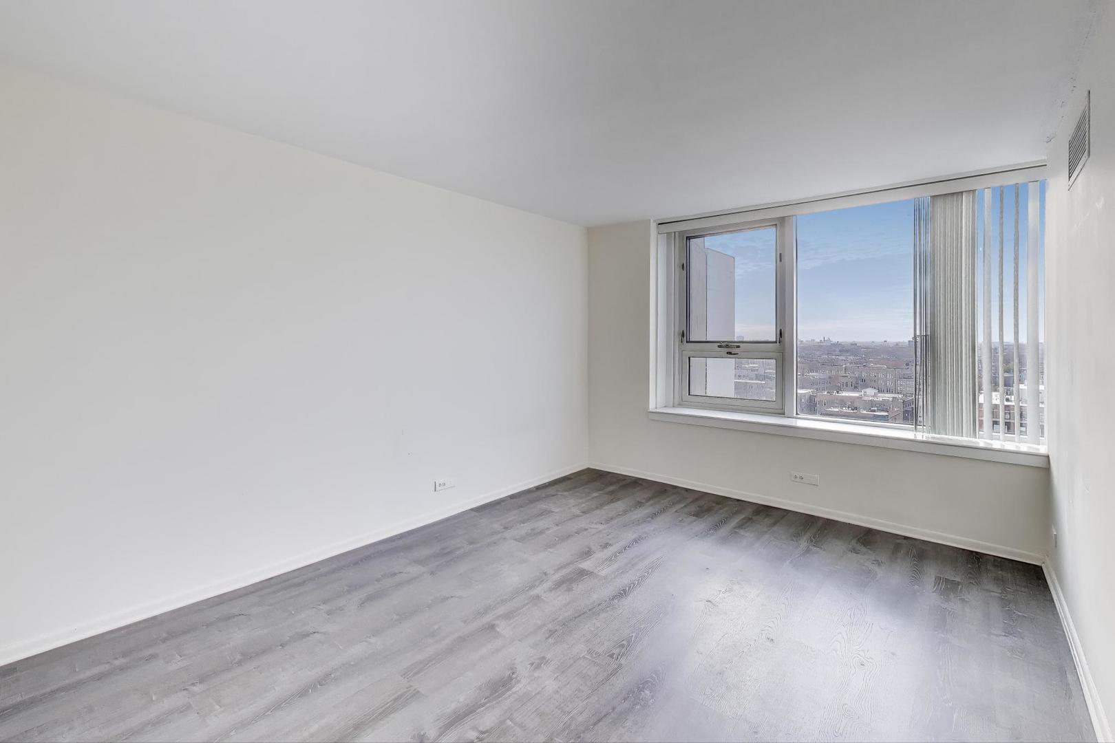 2728 North Hampden Court, Unit 1310 Chicago, IL 60614 - Photo 7 of 15 an empty room with wooden floor and windows