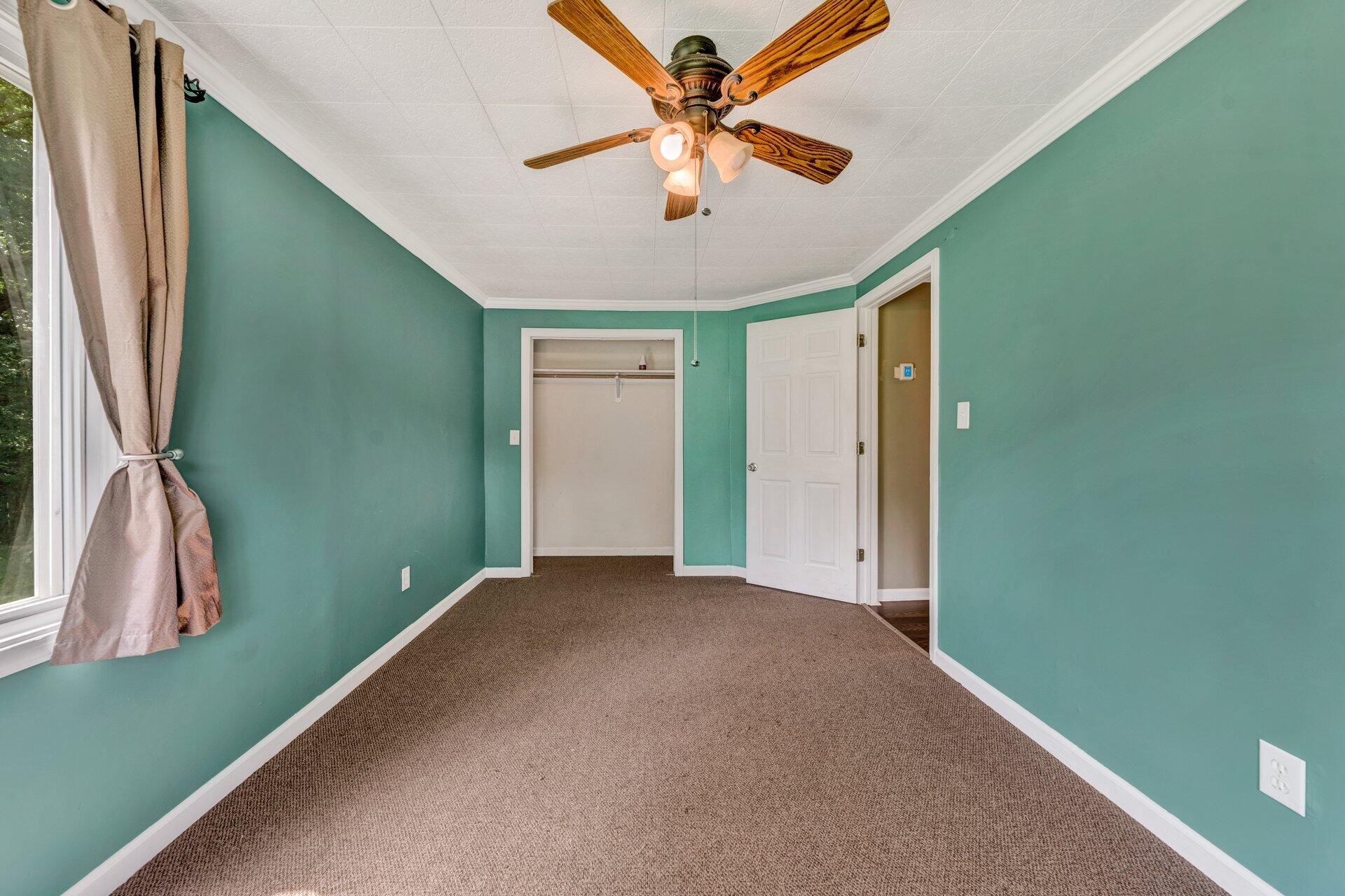 8342 Goodview Road Goodview, VA 24095 - Photo 15 of 30 a view of a room with a ceiling fan and a window