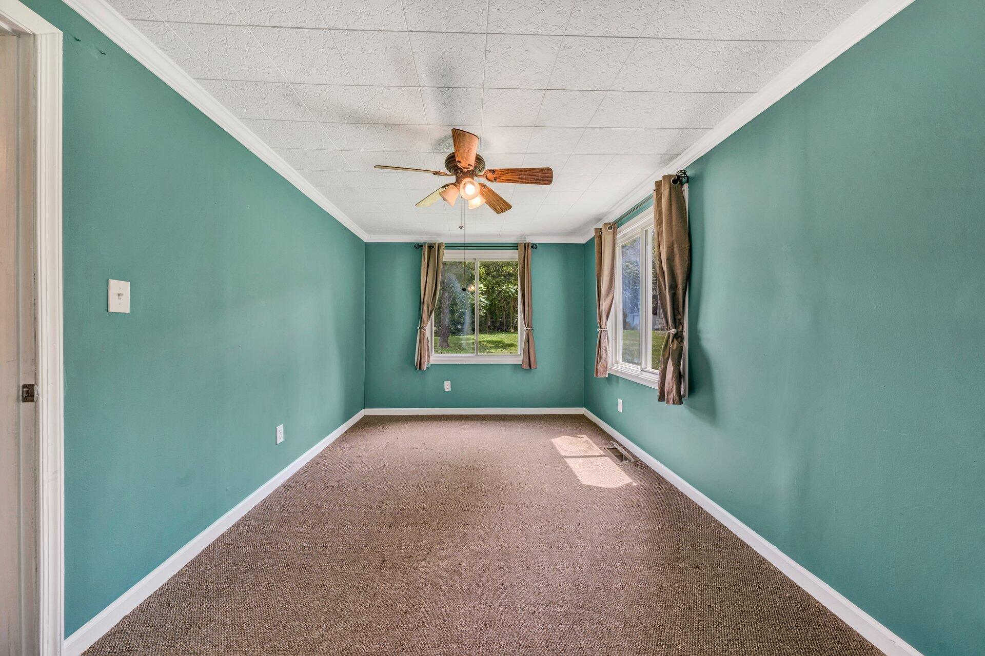 8342 Goodview Road Goodview, VA 24095 - Photo 16 of 30 a view of an empty room with window and chandelier fan