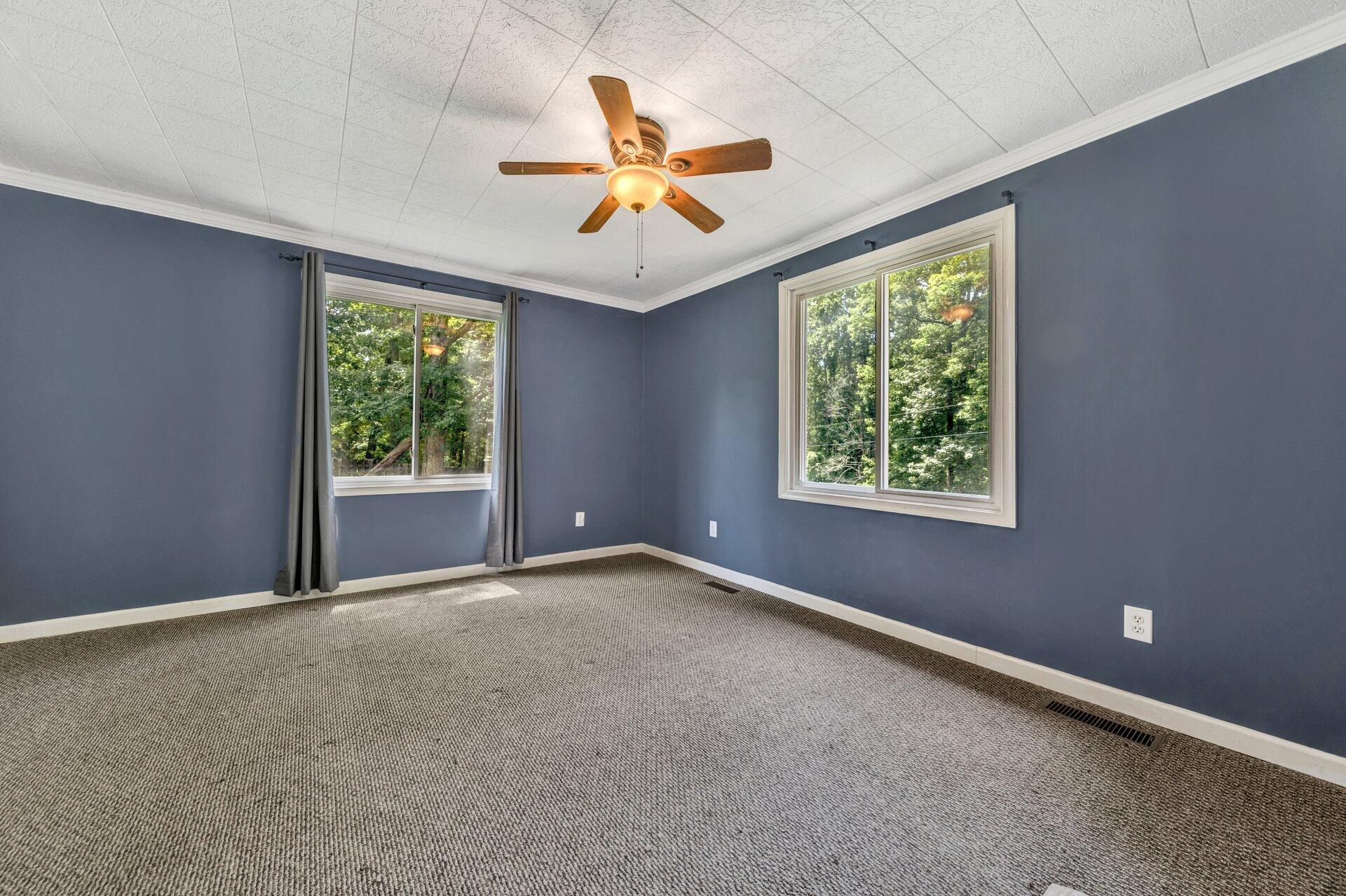8342 Goodview Road Goodview, VA 24095 - Photo 18 of 30 an empty room with windows and ceiling fan