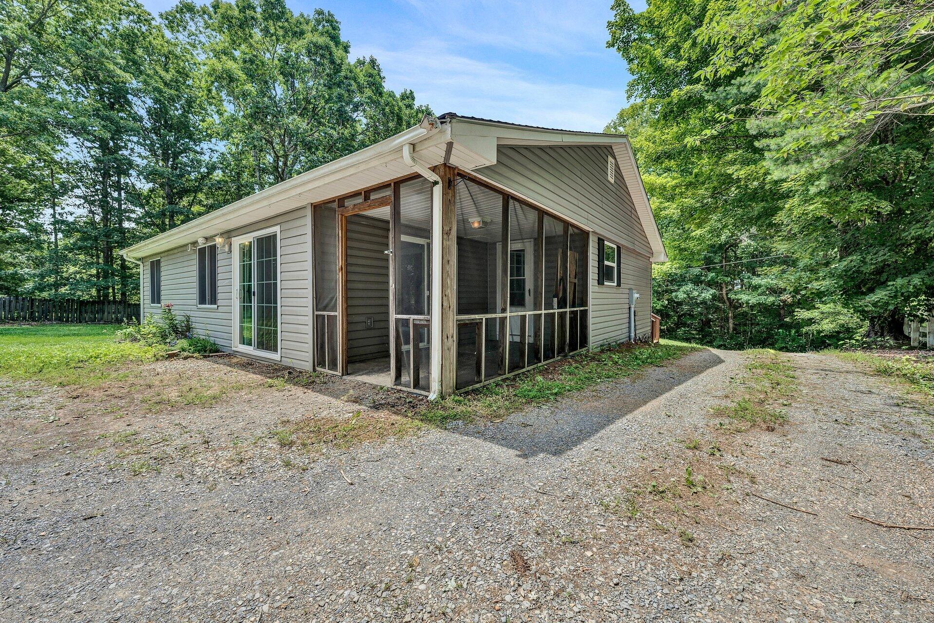 8342 Goodview Road Goodview, VA 24095 - Photo 23 of 30 a view of a house with a yard and potted plants