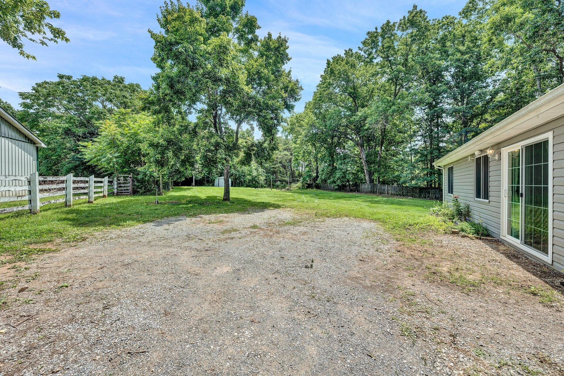 8342 Goodview Road Goodview, VA 24095 - Photo 28 of 30 a view of a house with a big yard and potted plants