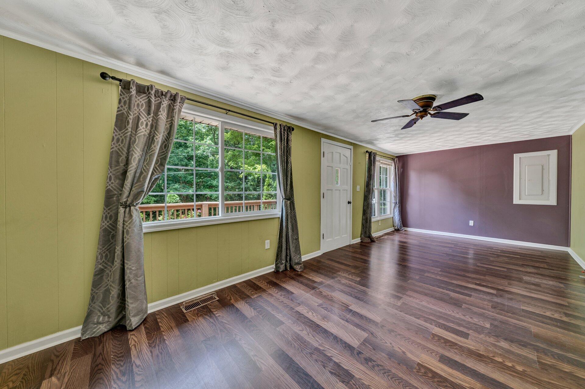8342 Goodview Road Goodview, VA 24095 - Photo 6 of 30 an empty room with wooden floor and a window