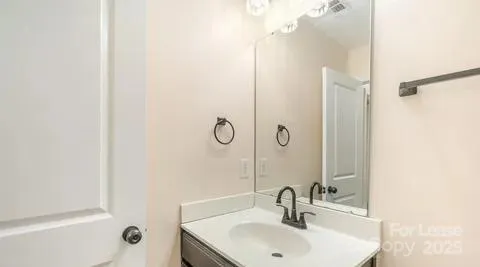 a bathroom with a sink and mirror