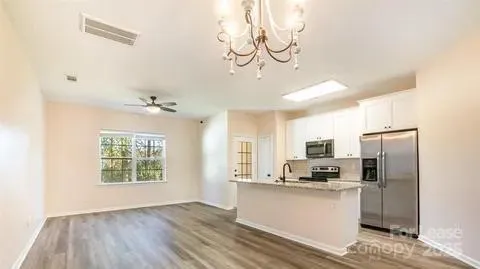 a kitchen with a refrigerator a stove a microwave and cabinets