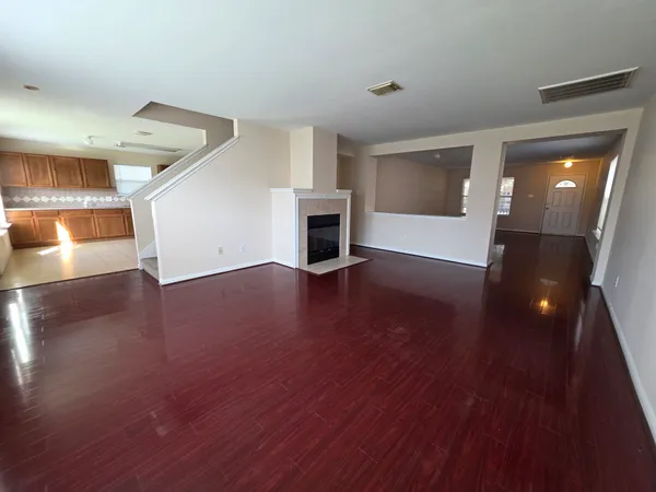 a view of a livingroom with wooden floor and fireplace