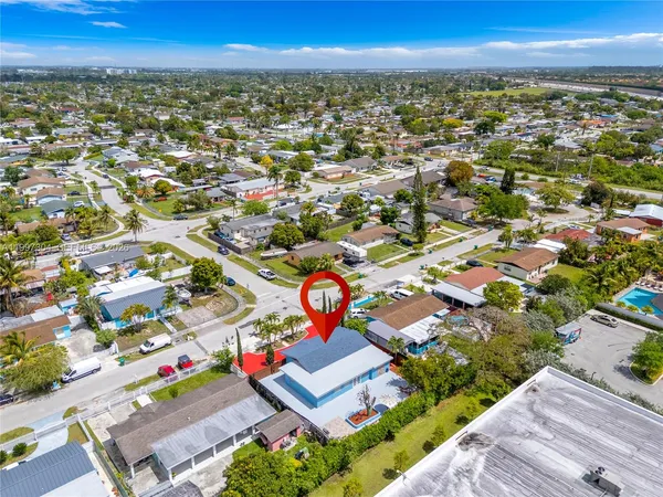an aerial view of residential houses with outdoor space