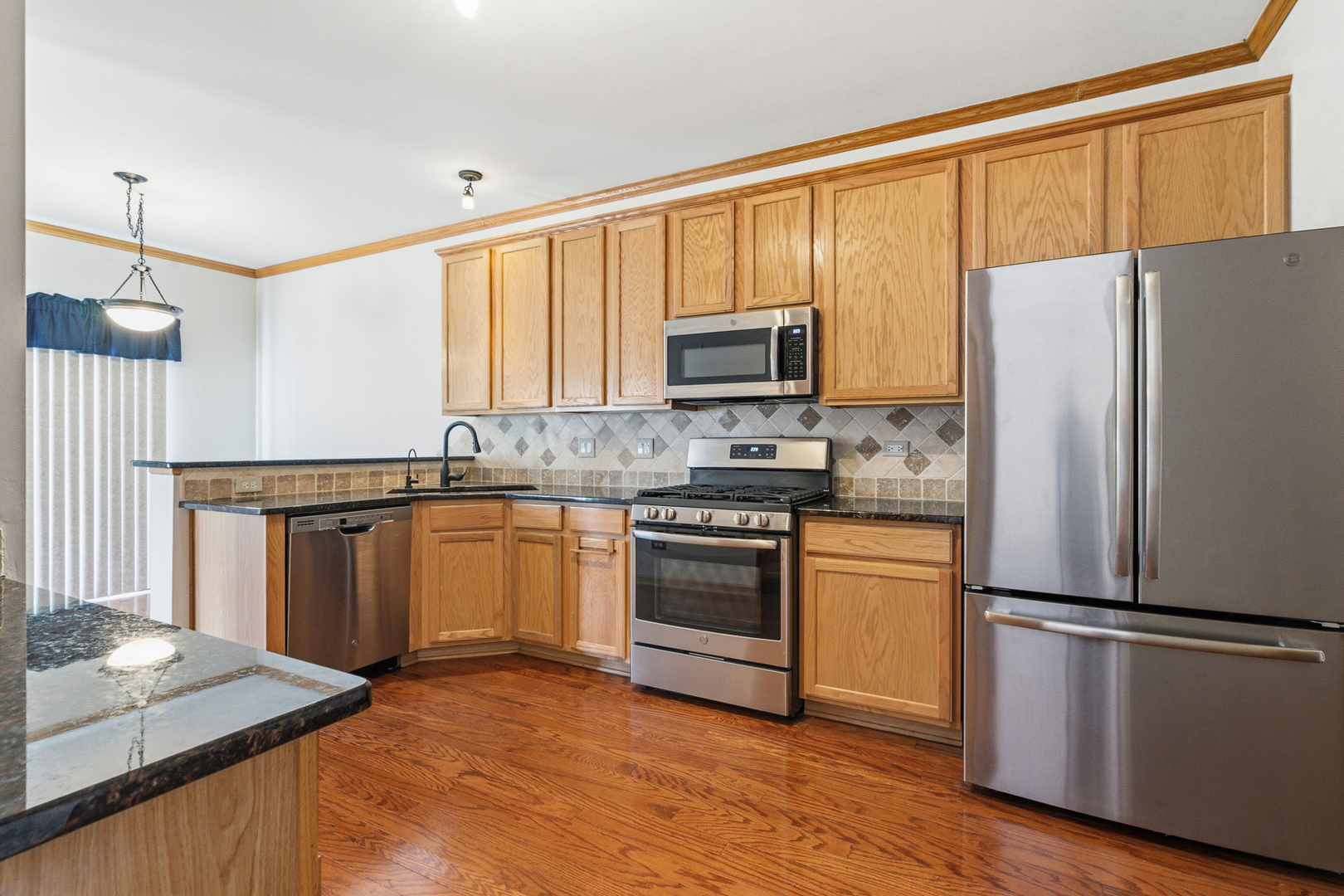 17656 Gilbert Drive Lockport, IL 60441 - Photo 4 of 32 a kitchen with a refrigerator sink and microwave