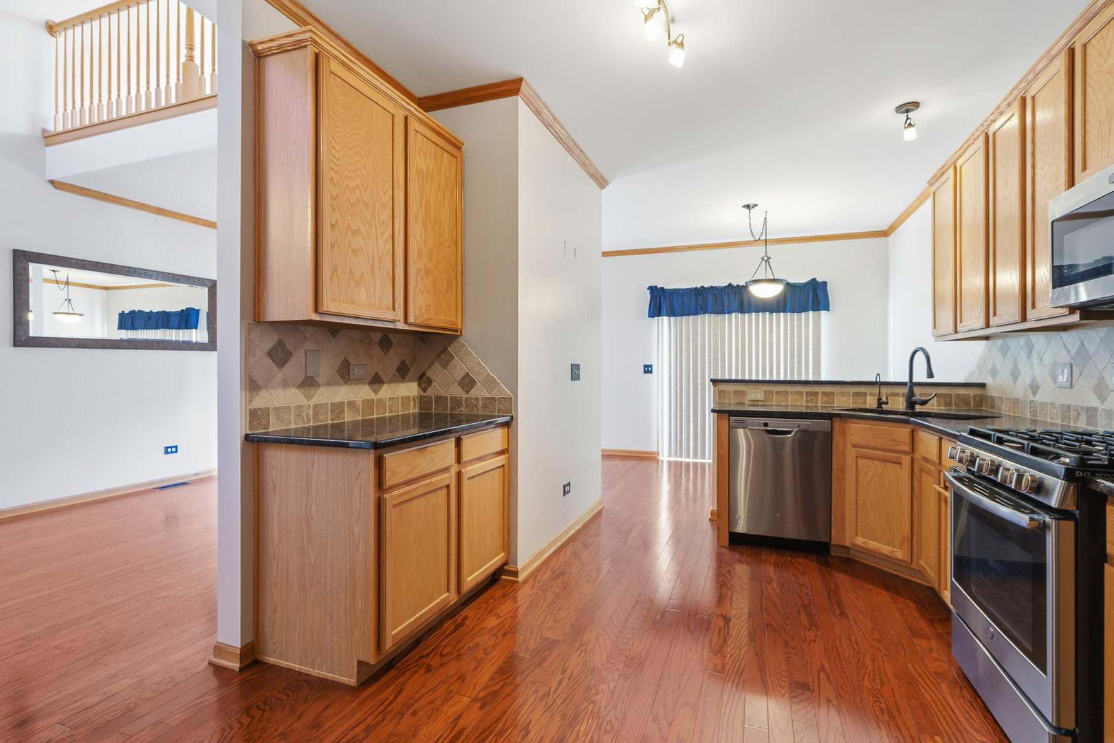 17656 Gilbert Drive Lockport, IL 60441 - Photo 6 of 32 a kitchen with granite countertop a sink cabinets stainless steel appliances and a window